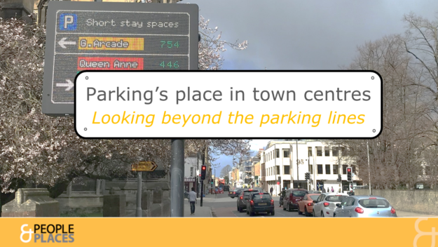 Electronic sign displaying parking availability alongside busy road